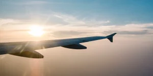 1VO7fg3W-airplane-wing-sunset-blue-sky-1