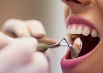 dentist-examining-female-patient-with-tools-1024x683.jpg
